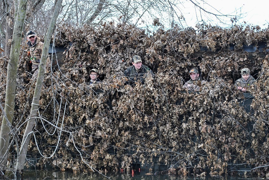 A group of youth hunters in a duck blind