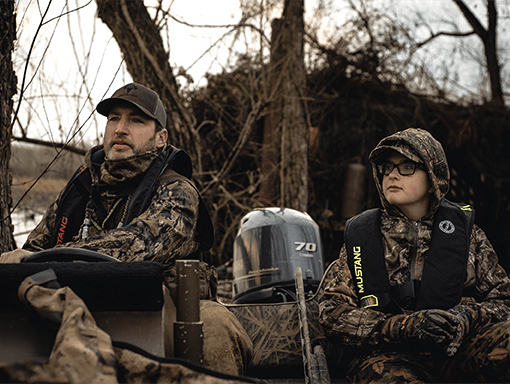 A student and teacher learning about duck hunting in the field