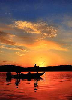 A lone fisherman at sunset