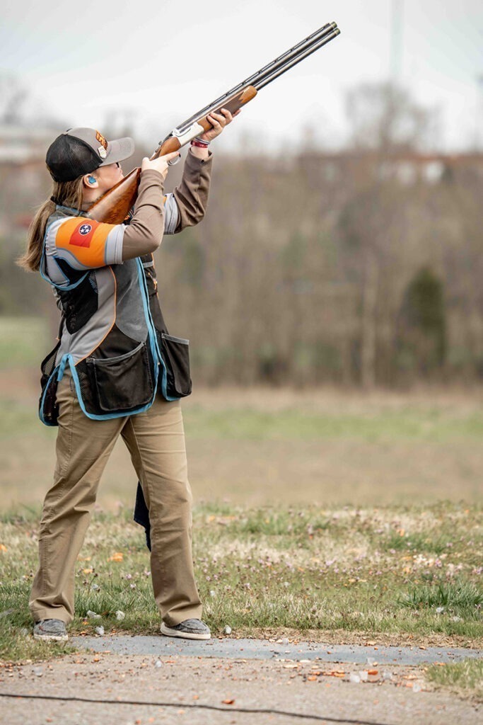 Athlete aiming her firearm