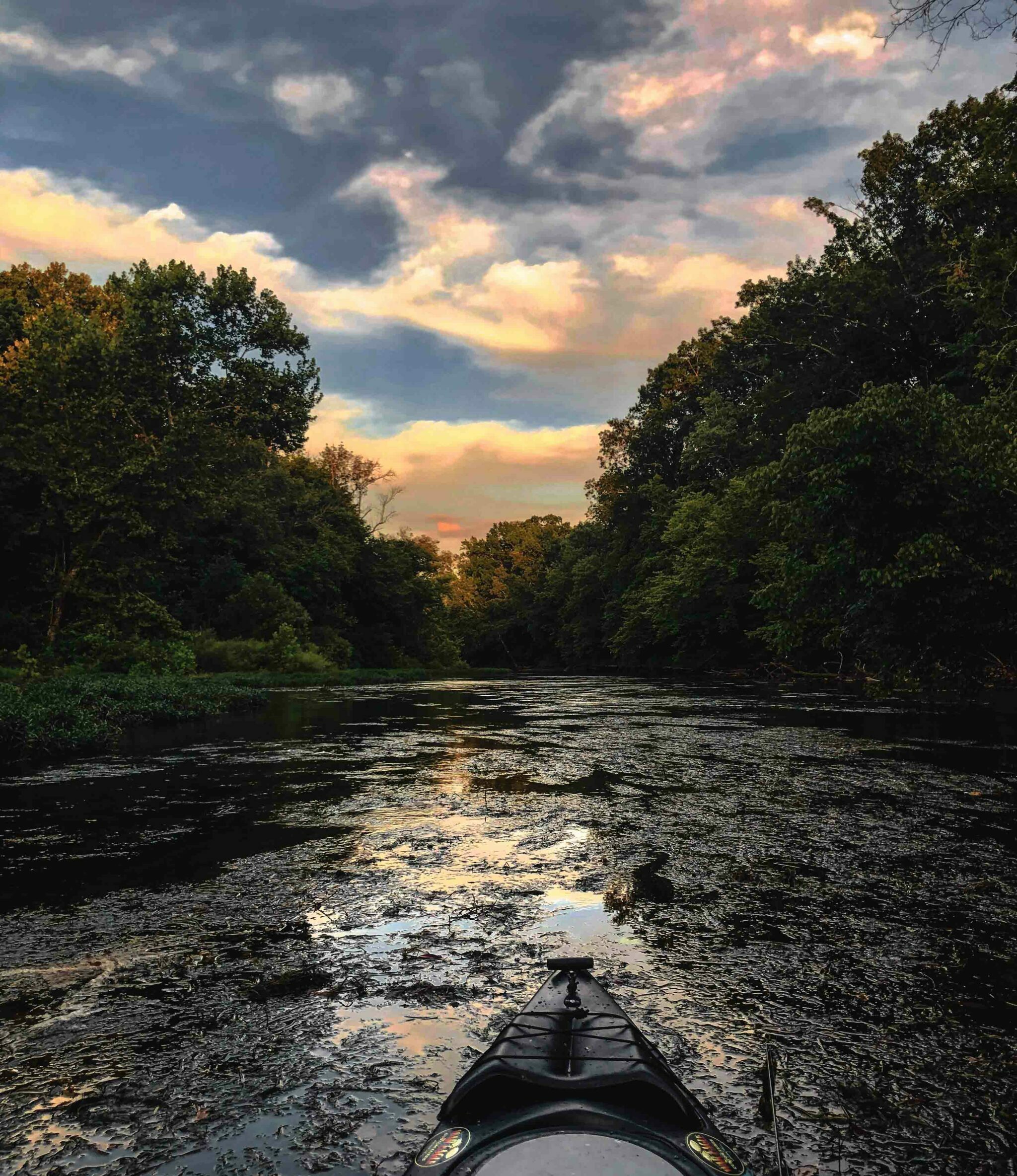 Kayak on river by Adam Whitman