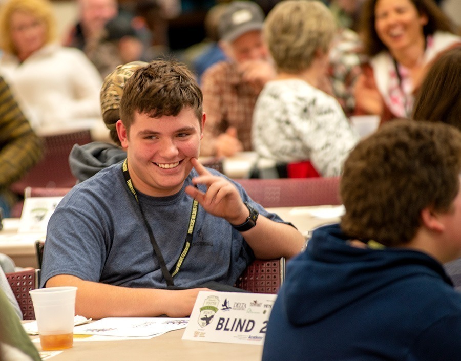 A youth participant smiles at the banquet on Friday night.