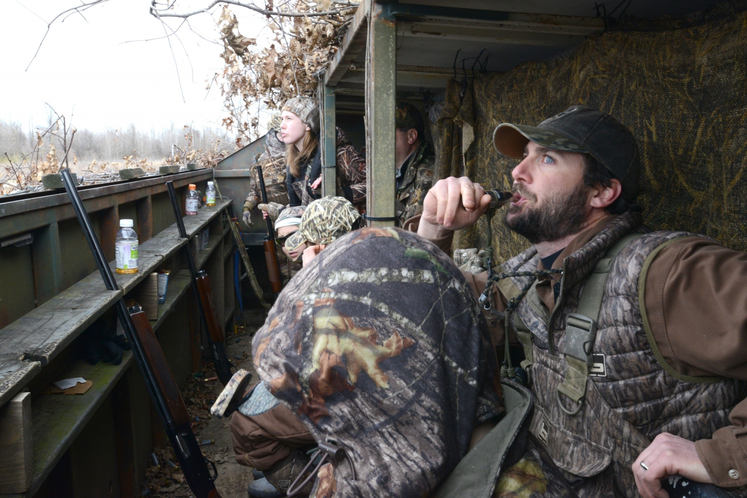 Man blowing a duck call.