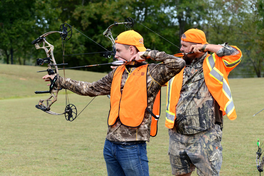 Father and son practicing archery at Hunting and Fishing Academy