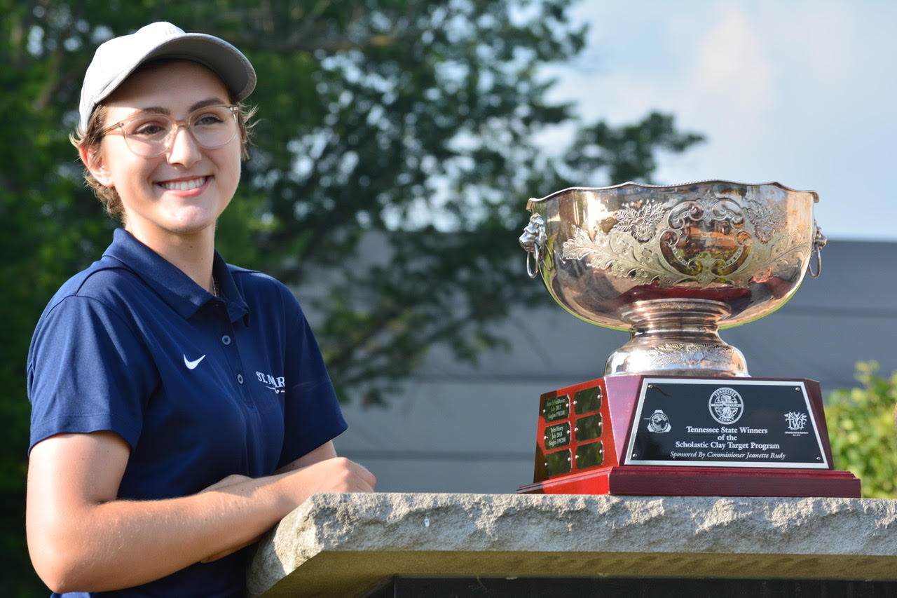 Emily Ferguson poses next to The Rudy Cup, which is awarded to the highest-scoring trapshooter from Tennessee at Nationals.