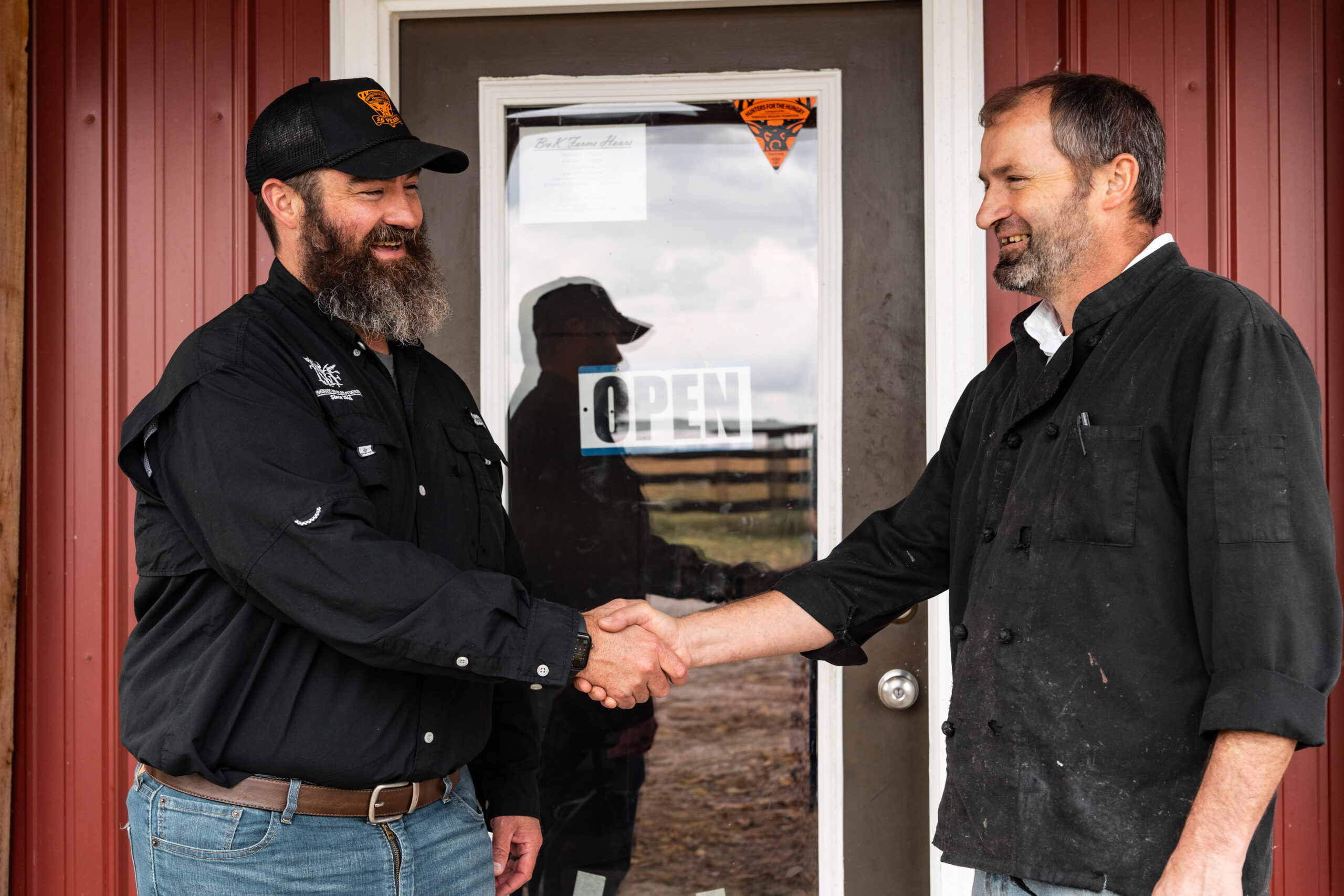 Matt Simcox, Hunters for the Hungry manager, shakes the hand of an employee at B&K Processing in Dickson County.