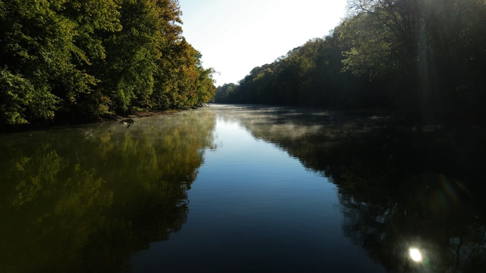 Fly fisherman surrounded by kayakers